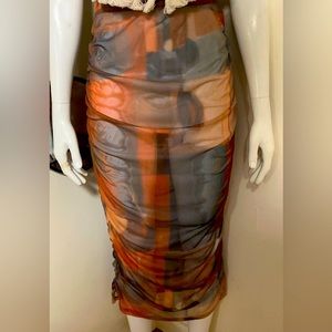 This skirt is a little see through, like a mesh material. Unworn w/ tag